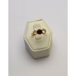 A three stone red and white stone ring,