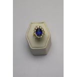 An oval sapphire and diamond cluster ring,