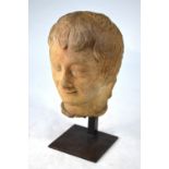 An antique French carved stone head 'Le Sourire de Reims', 23 cm high,