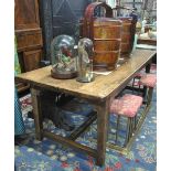 An antique oak/elm refectory table, the wide four plank top with cleated ends,