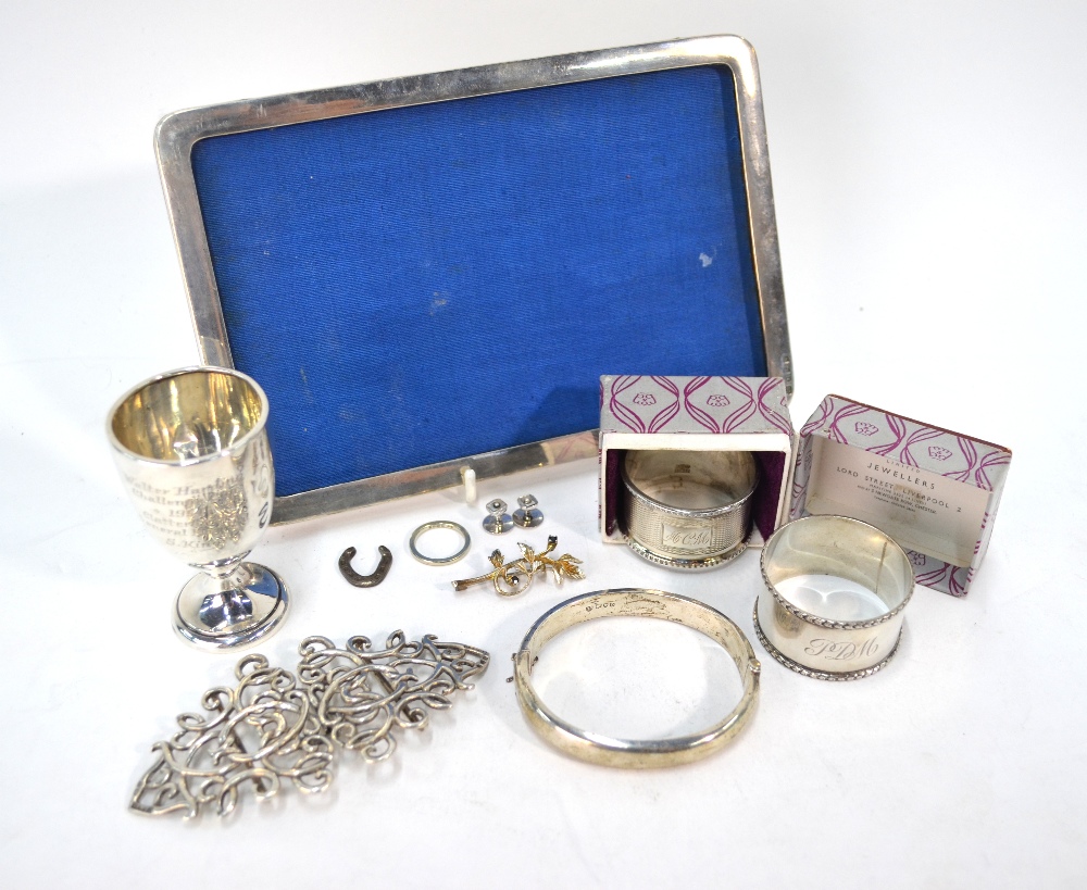 Various oddments of silver, including two napkin rings, a small trophy cup, photograph frame,