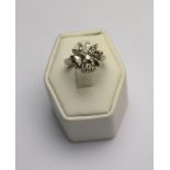 A pierced coronet style ring set with brilliant cut diamond in centre,