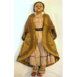 An 18th century wax head doll with fixed glass eyes and soft body, in original clothing,