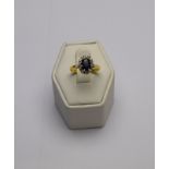 An oval sapphire and diamond cluster ring,