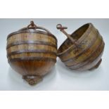 A pair of iron mounted wood storage vessels with circular iron suspension rings,