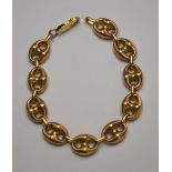 A yellow coloured metal cable chain bracelet formed of hollow links stamped 375,