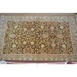A handmade Persian Heriz design small carpet, the stylised floral vine design on mid-brown ground,