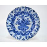 A Chinese blue and white dish, decorated with a central panel of a flower arrangement, 20.