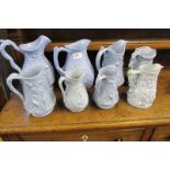 Eight Victorian blue ceramic relief jugs.