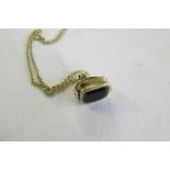 9ct gold swing fob and gold chain.