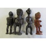 Four African carved wood figures.