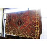 Persian rug with diamond star and lozenge design, 77” x 60”.