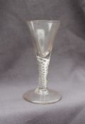 An 18th century wine glass with a tapering bowl to an air twist stem on a spreading foot, 14.