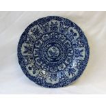 A Japanese blue and white porcelain plate decorated with scrolling flowers, 24.