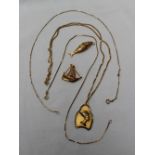 An 18ct yellow gold pendant with an Egyptian head on an 18ct yellow gold chain,