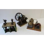 A Live Steam Stationary Engine consisting of horizontal brass boiler and flywheel on a wooden base,