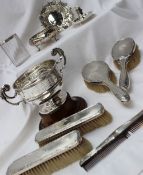 A George V Silver part dressing table set, Birmingham, 1929 together with a silver trophy cup,