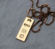 A 9ct yellow gold ingot, on a 9ct yellow gold box link chain,