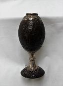 A white metal mounted carved coconut cup decorated with figures,