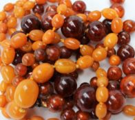 A double strand amber necklace with graduating spherical beads to a yellow metal clasp together