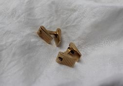 A pair of 9ct yellow gold cufflinks, with textured wedge shaped hinged ends,