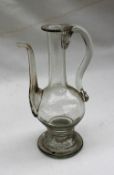 A 19th century glass oil pot with a baluster body on a spreading foot,