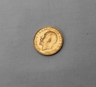 A George V gold sovereign,