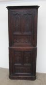An 18th century carved oak standing corner cupboard,