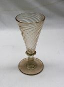 A 19th century ale glass with a wrythen twisted tapering bowl on a ring turned stem and spreading