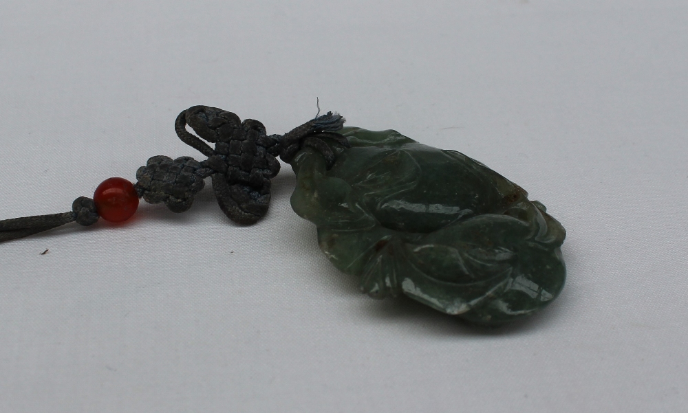 A carved jade pendant in the form of fruit and leaves on a cord necklace 55mm x 35mm - Image 3 of 3