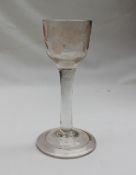An 18th century dram glass, with rounded bowl embellished with etched flower and bird decoration,