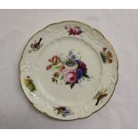 A Nantgarw porcelain plate with a scalloped gilt rim,