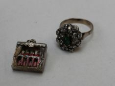 An emerald and diamond dress ring to a white metal setting and a can-can pendant