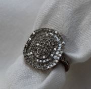 A diamond dress ring of oval form set with round brilliant and baguette cut diamonds to a 9ct