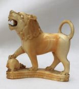 A 19th century carved ivory lion, with its right paw raised on a rat, 5.