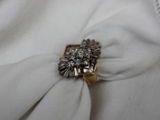 A diamond cluster ring set with nine round brilliant and baguette cut diamonds totalling
