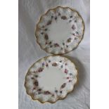 A pair of Royal Crown Derby plates, with a flared rim,