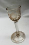 An 18th century dram glass, with rounded bowl embellished with etched flower and bird decoration,