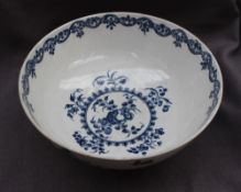 An early 18th century Worcester blue and white bowl decorated in the "fruit and wreath" pattern,