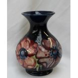 A Moorcroft pottery baluster vase, in the anemone pattern to a royal blue ground,