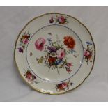 A Nantgarw porcelain plate with a gilt scalloped rim,