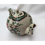 An 18th century saltglazed teapot, painted with sprays of garden flowers, 11cm high x 19.