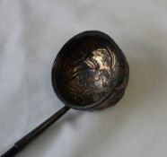 A white metal ladle with twisted handle,