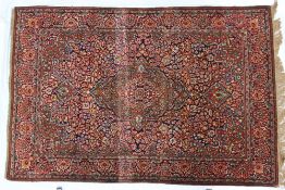 A pair of Isfahan type rugs with a central medallion with a floral and leaf ground,