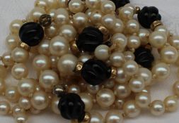 A three strand pearl and twisted bead necklace to a yellow metal clasp,