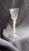 An 18th century wine glass, with a tapering bowl embellished with honeycomb decoration,