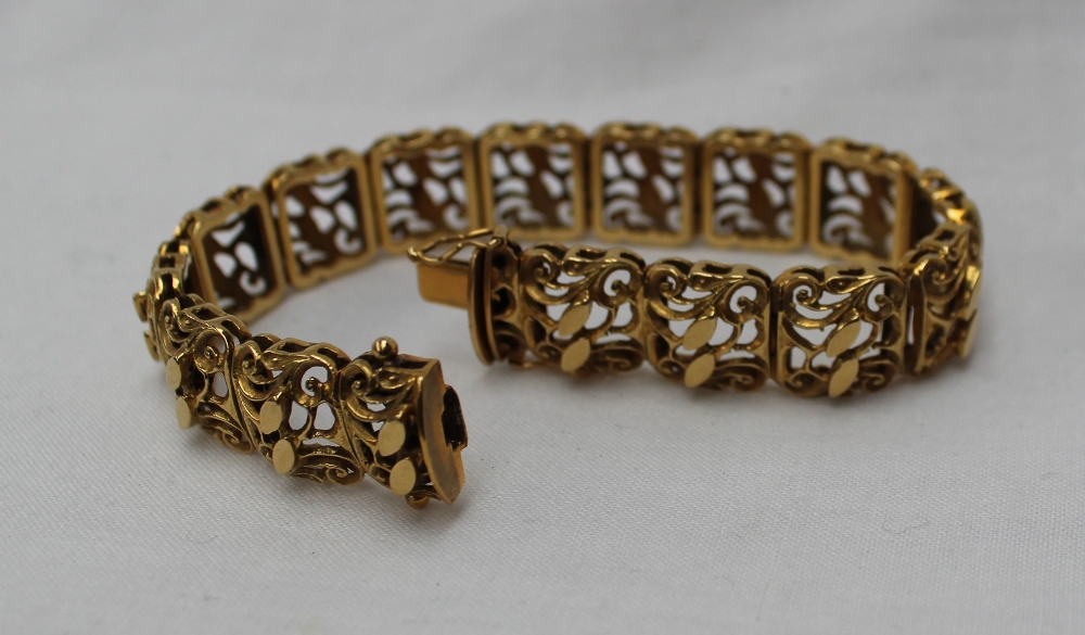 A yellow metal bracelet with rectangular pierced scrolling links, - Image 2 of 3