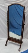 A mahogany cheval mirror, the rectangular plate with a moulded top between square tapering uprights,