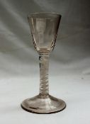 An 18th century wine glass, with a tapering bowl decorated with stop fluting,