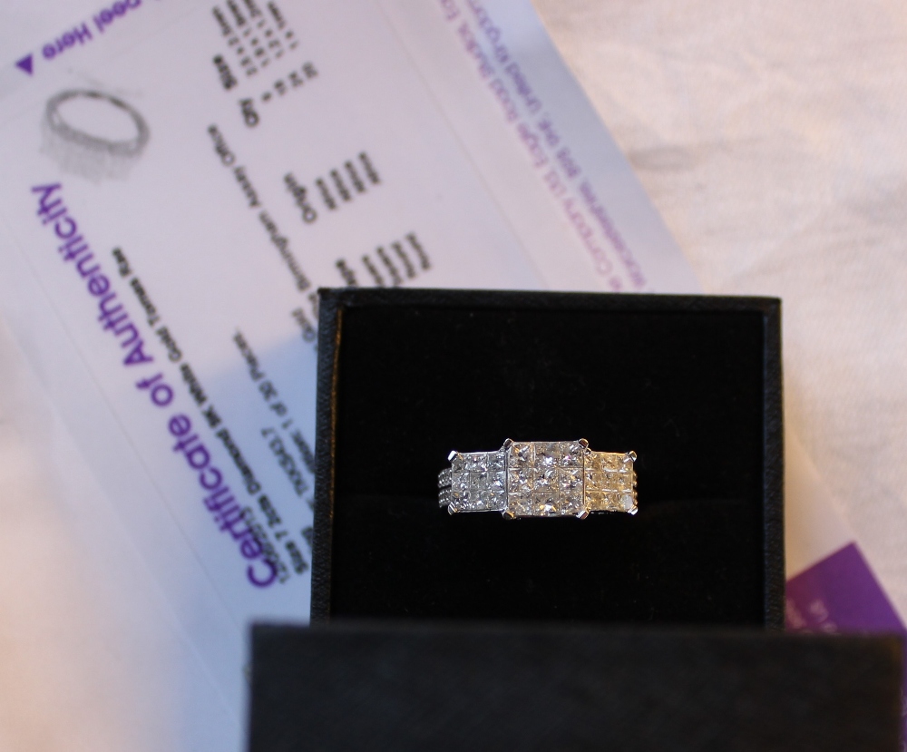 A diamond cluster ring set with princess cut diamonds totalling approximately 2cts to a 9ct white